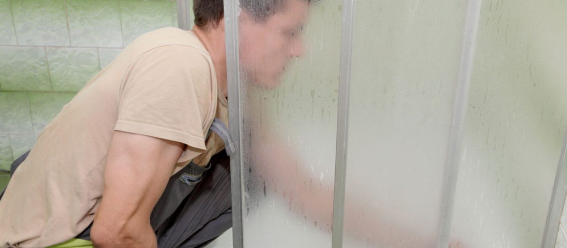 Man installing a shower door